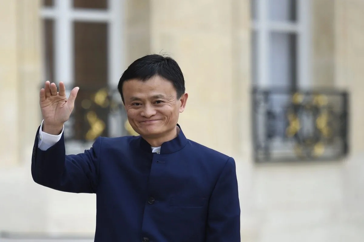 Chinese entrepreneur and founder of internet retail group Alibaba, Jack Ma, waves to journalists as he arrives for a meeting with French President Francois Hollande at the Elysee Palace in Paris on March 18, 2015. (MARTIN BUREAU/AFP/Getty Images)