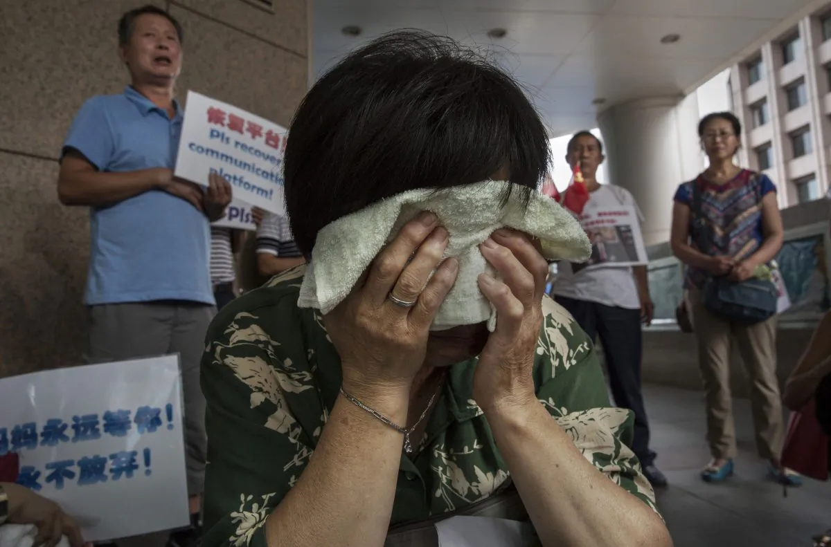 Bao Lanfang, a Chinese relative of missing passengers on Malaysia Airlines flight MH 370 cries as she waits for information outside the airline's office on August 6, 2015 in Beijing, China.
 (Kevin Frayer/Getty Images)
