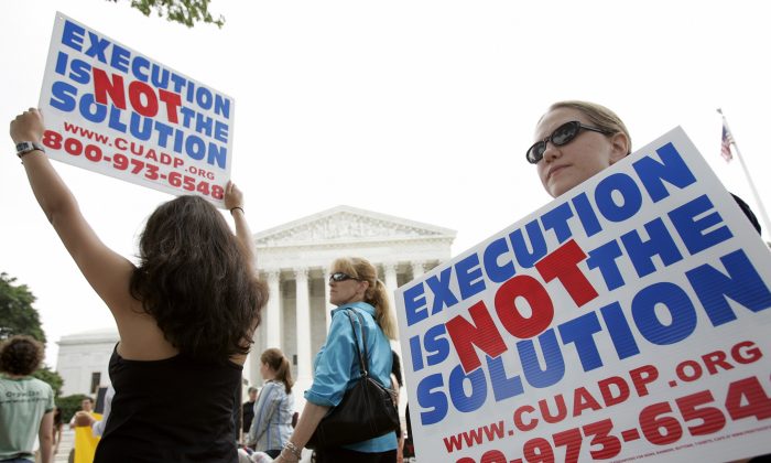 Anti death penalty activists rally outside the U.S. Supreme Court June 29, 2005 in Washington, DC. The group rallied during their 12th annual vigil and fast they call 'Starvin for Justice 2005' held from June 28-July 2. (Photo by Brendan Smialowski/Getty Images)
