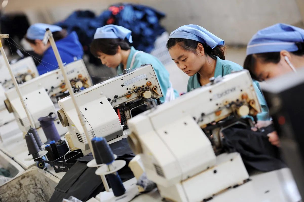 Workers produce clothes in a factory in China's Anhui Province in 2014. (STR/AFP/Getty Images)