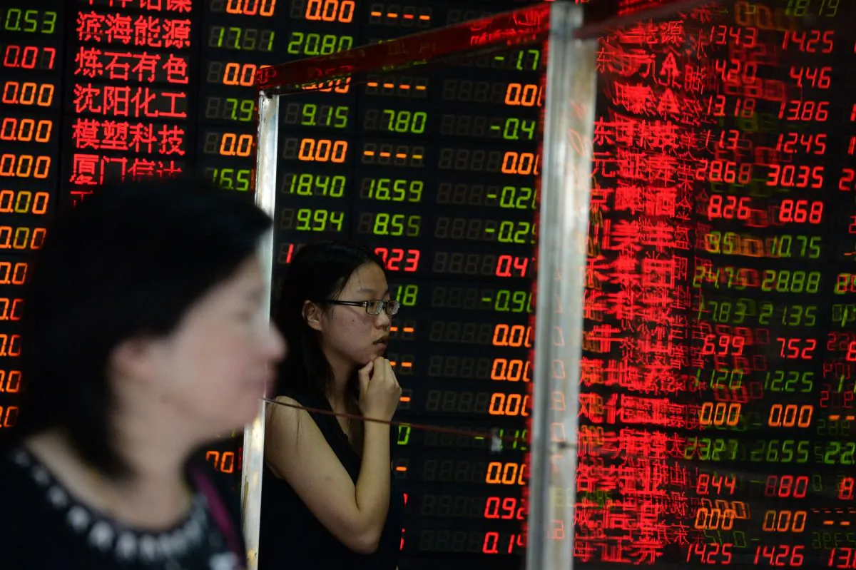 Investors check a screen displaying share prices at a security firm in Shanghai on July 6, 2015.     (STR/AFP/Getty Images)