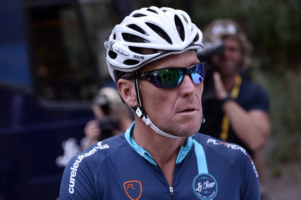 Lance Armstrong gets ready in Rodez, southwest France, prior to ride a stage of The Tour De France for a leukaemia charity, a day ahead of the competing riders, on July 17, 2015. For the first time since he was stripped of his seven Tour de France titles, Armstrong rode a stage of the famous race for charity. (Stephane De Sakutin/AFP/Getty Images)
