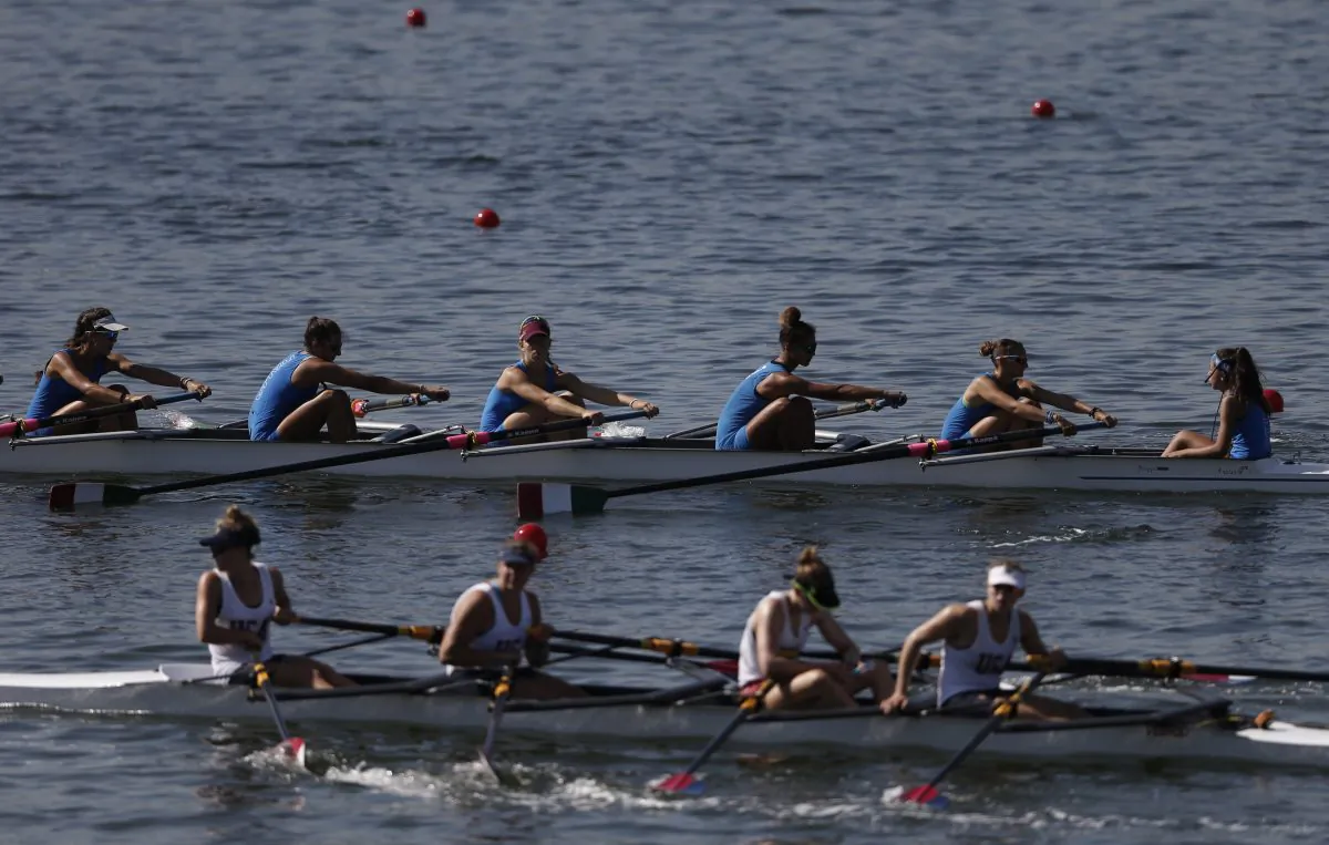 Teams of rowers from Italy, top, and the U.S., bottom, practice for the 2015 World Rowing Junior Championships on Rodrigo de Freitas lake in Rio de Janeiro, Brazil, Tuesday, Aug. 4, 2015. (AP Photo/Silvia Izquierdo)