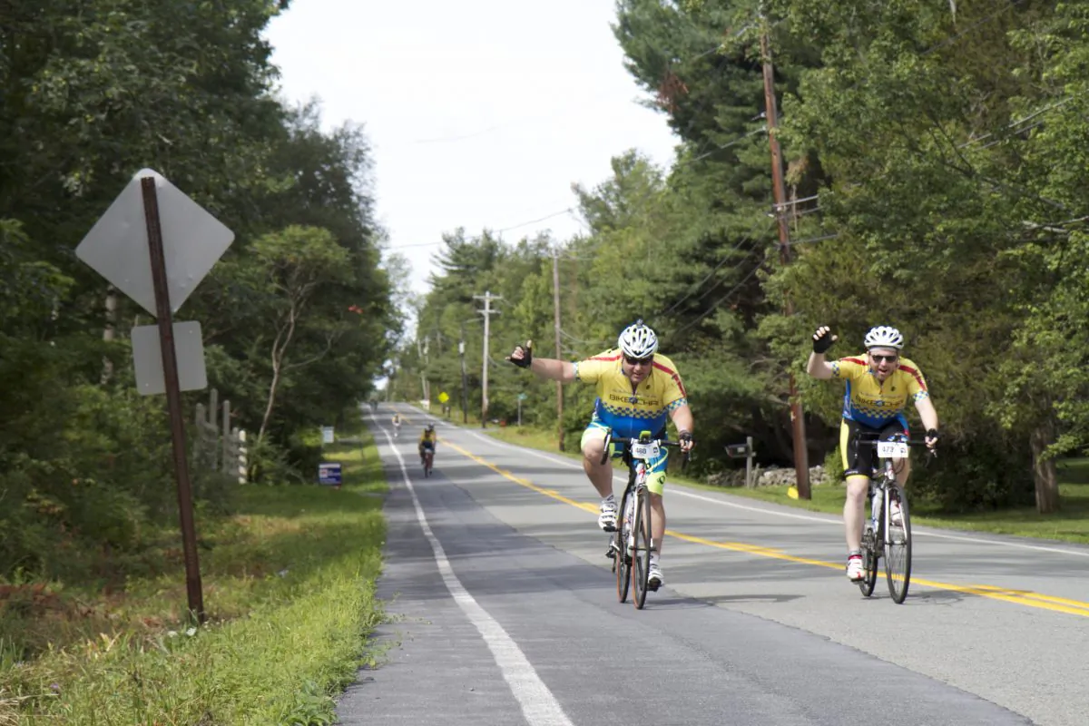 Bike 4 Chai cyclists #460 and #473 ride down Guymard Turnpike towards the Mount Hope Park in Otisville, NY, on day two of the 180 mile charity ride, on Thursday, Aug. 6, 2015. (Katy Mantyk/Epoch Times)
