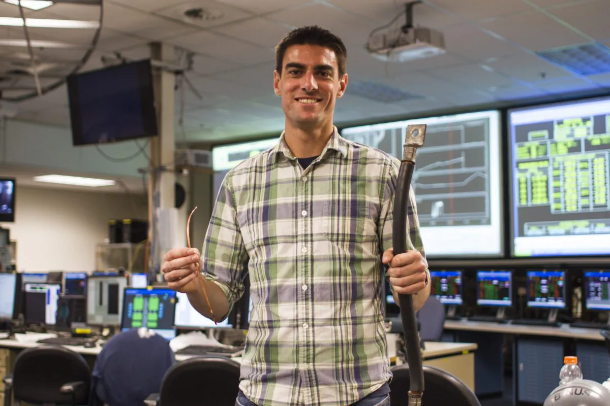 MIT PhD candidate Brandon Sorbom holds REBCO superconducting tapes (left), which are the enabling technology behind the ARC reactor. (Jose-Luis Olivares/MIT) 