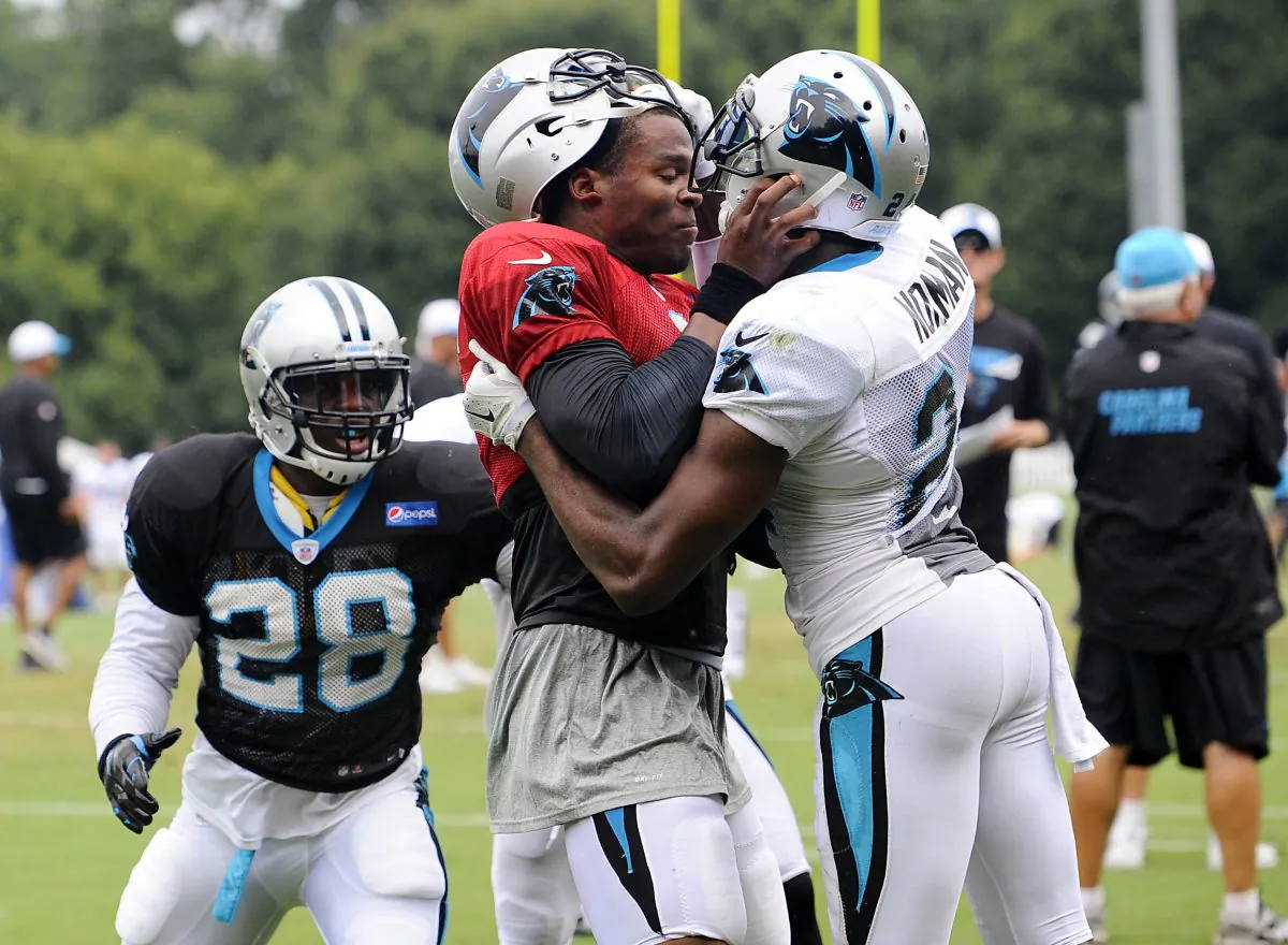 Carolina Panthers' Cam Newton (1) and Josh Norman (24) scuffle at the teams NFL football training camp at Wofford College in Spartanburg, S.C., Monday, Aug. 10, 2015. (David T. Foster III/The Charlotte Observer via AP) 