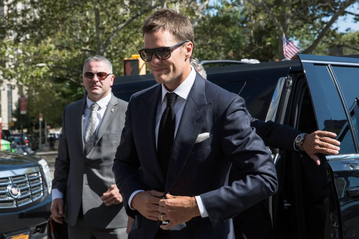 New England Patriots' quarterback Tom Brady arrives at federal court to appeal the National Football League's (NFL) decision to suspend him for four games of the 2015 season on August 12, 2015 in New York City. The NFL alleges that Brady knew footballs used in one of last season's games was deflated below league standards, making it easier to handle. (Andrew Burton/Getty Images)