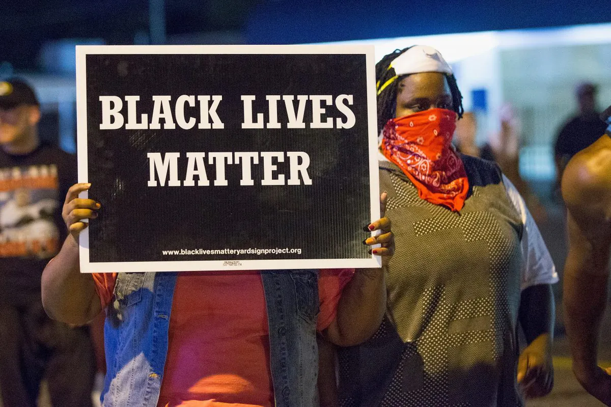 Demonstrators, marking the one-year anniversary of the shooting of Michael Brown, protest along West Florrisant Street on August 10, 2015 in Ferguson, Missouri. (Photo by Scott Olson/Getty Images)