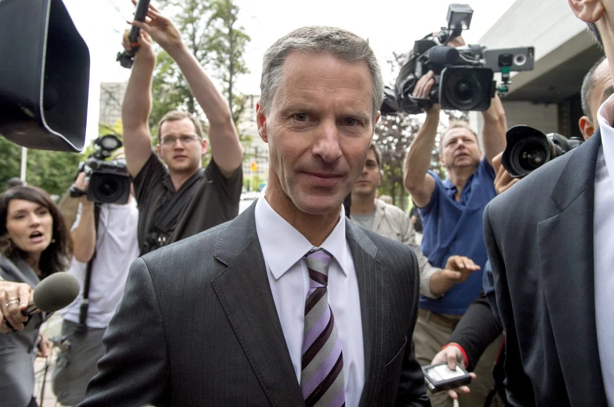 Nigel Wright, former chief of staff to Prime Minister Stephen Harper, makes his way through a crush of media as he arrives to testify at the criminal trial of embattled Sen. Mike Duffy in Ottawa on Aug. 12, 2015. (The Canadian Press/Justin Tang)