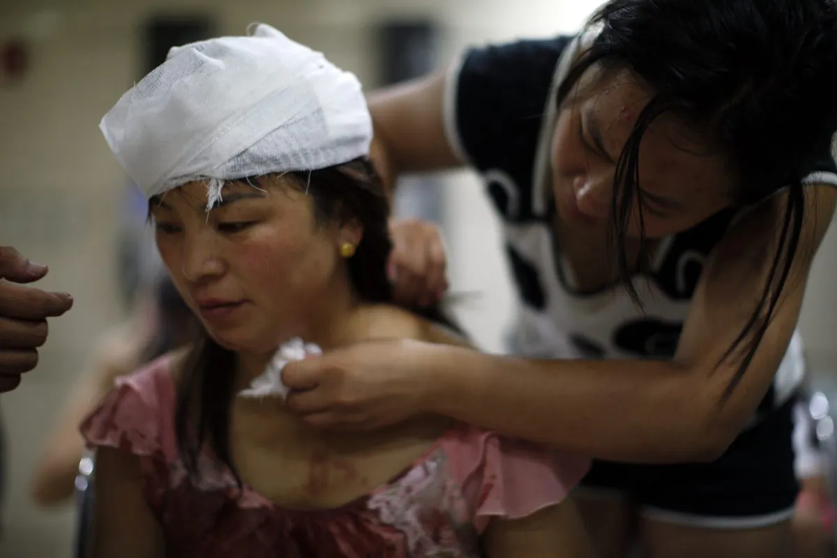 An injured woman is treated inside a hospital following explosions in northeastern China's Tianjin municipality, Thursday, Aug. 13, 2015. (Chinatopix Via AP)