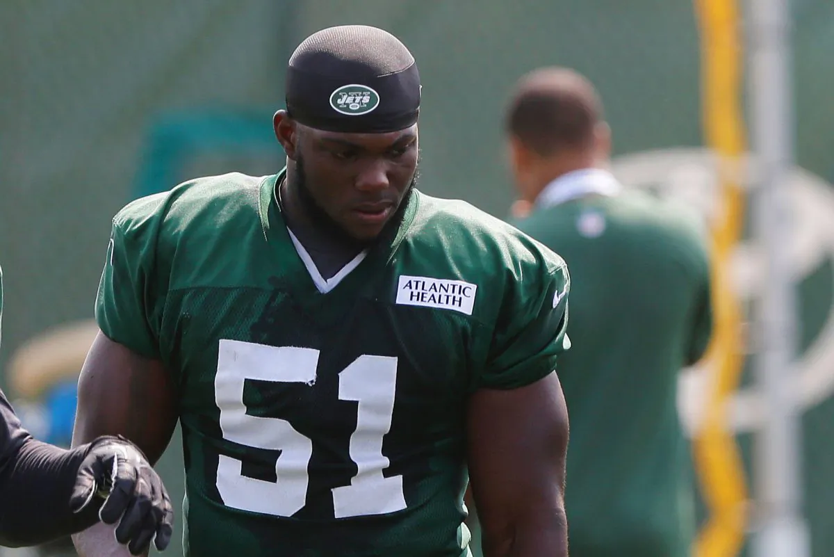 In this July 25, 2014, file photo, New York Jets' Ikemefuna Enemkpali (51) listens to a coach during an NFL football training camp in Cortland, N.Y. (AP Photo/File)