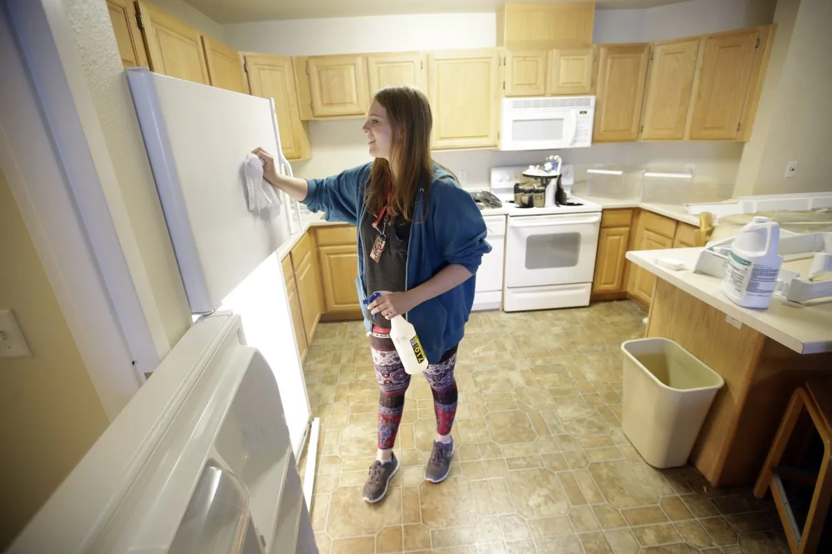 In this Friday, Aug. 7, 2015, student Emilee Gull cleaning a dorm room in Eccles Living Learning Center at Southern Utah University, in Cedar City, Utah. (AP Photo/Rick Bowmer)