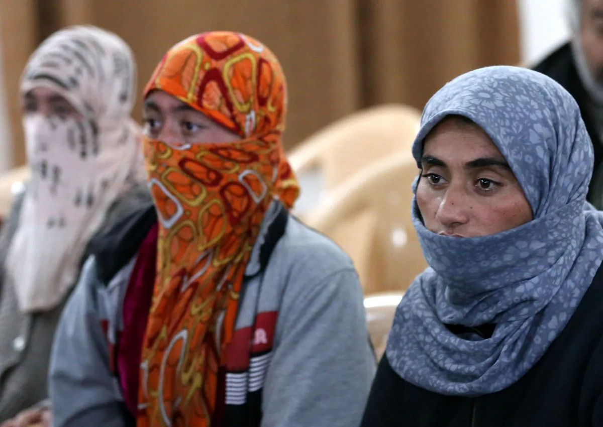 Yazidi women at Al-Tun Kopri Health Center, between the northern Iraqi city of Kirkuk and Arbil, on Jan. 17, 2015. They were released with around 200 mostly elderly members of Iraq's Yazidi minority near Kirkuk after being held by the Islamic State jihadist group for more than five months. (Safin Hamed/AFP/Getty Images)