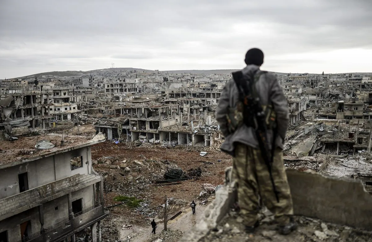 Musa, a 25-year-old Kurdish marksman, looks at the destroyed Syrian town of Kobani, on Jan. 30, 2015. (Bulent Kilic/AFP/Getty Images)