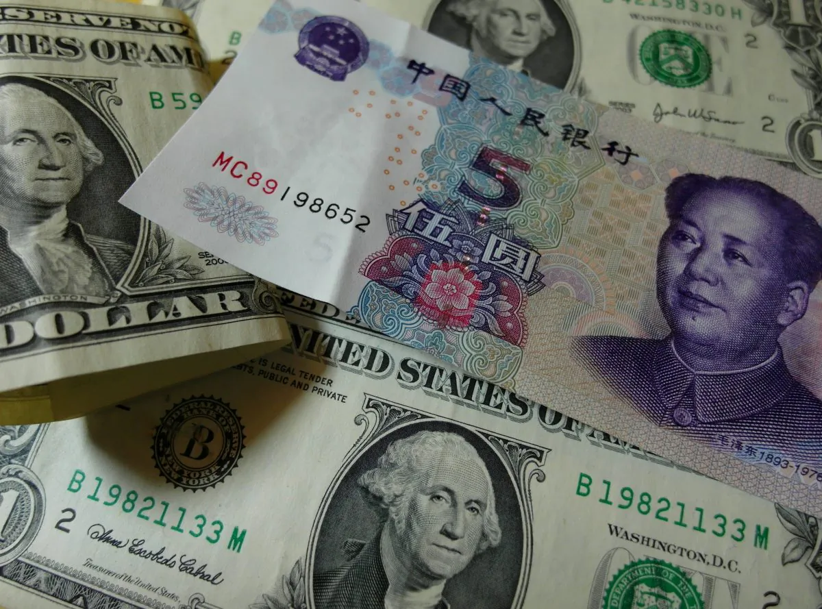 Yuan banknotes and US dollars on a table in Yichang, central China's Hubei province on Aug. 14. (STR/AFP/Getty Images)