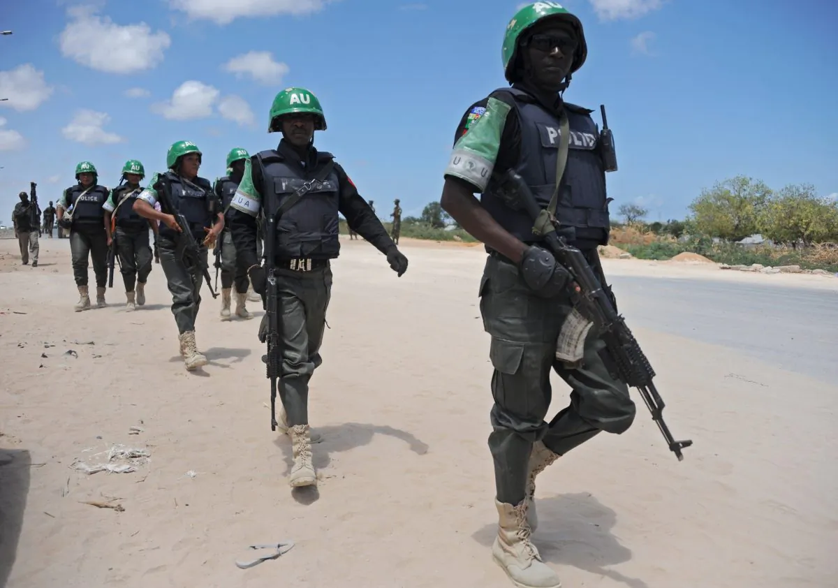 African Union Mission in Somalia (AMISOM) officers patrol around the Gashandhiga academy compound during celebrations of the 55th anniversary of the Somali military force, in Mogadishu, on April 12, 2015. (Mohamed Abdiwahab/AFP/Getty Images)