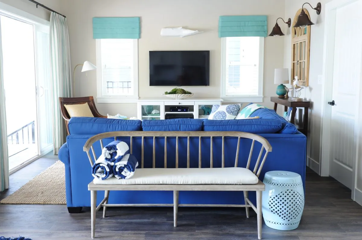 The blue sofa in the living room adds a nautical, casual, summer house feel. (Tracey Ayton, www.traceyaytonphotography.com)