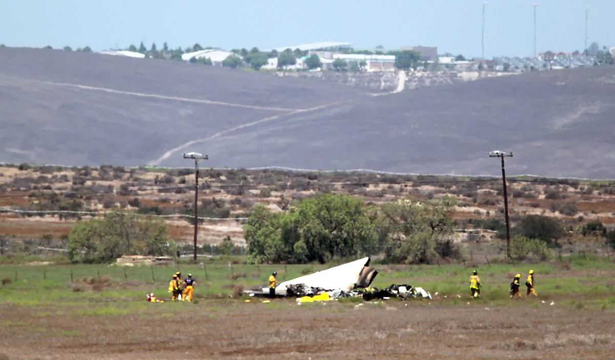 Authorities say multiple people died following the midair collision and crash of two small planes near an airport in southern San Diego County. (John Gastaldo/U-T San Diego via AP)