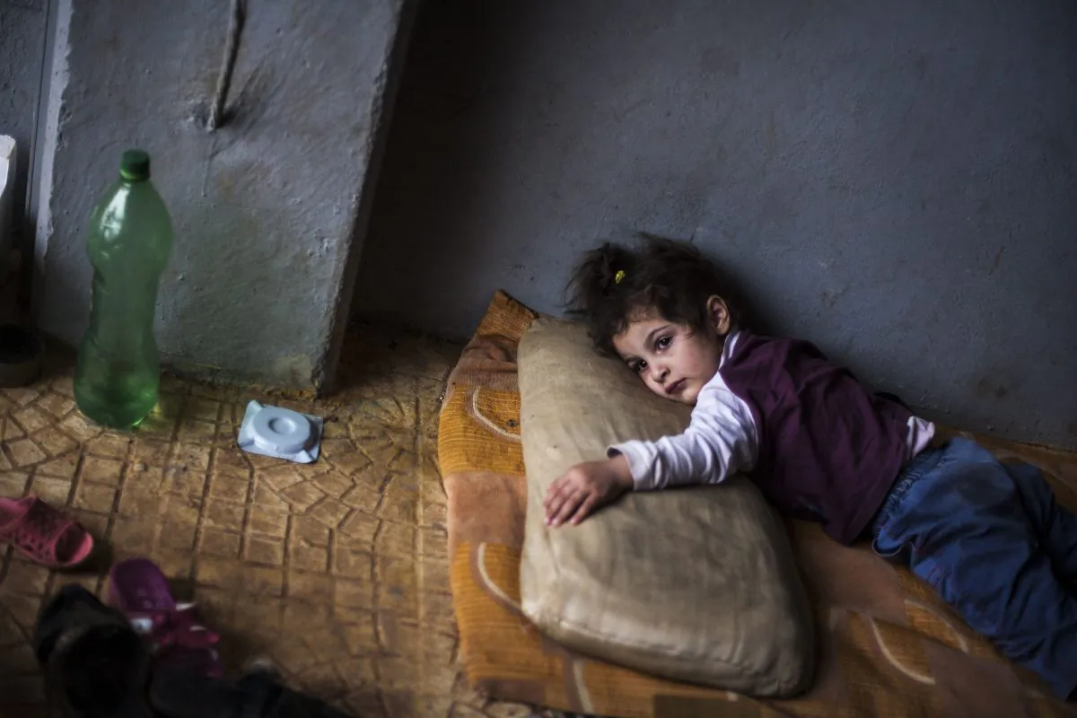 Rada Hallabi, 4, who is sick with diabetes, lies on a blanket  in a refugee camp on the border with Turkey, near Azaz village, Syria, Sunday, Sept. 30, 2012. (AP Photo / Manu Brabo)