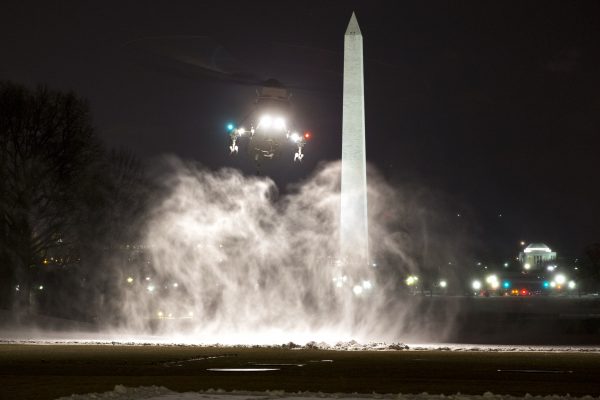 Snow billows in the air as the Marine One helicopter, carrying President Barack Obama, lands on the South Lawn of the White House, on his return from Chicago, Thursday, Feb. 19, 2015, in Washington. (AP Photo/Jacquelyn Martin)