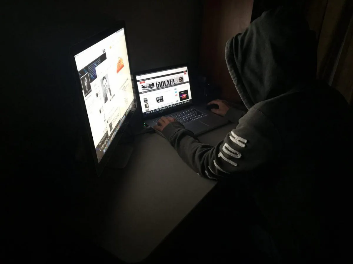 An operative of the hacker group GhostSec works at a laptop. The organization was formed to fight ISIS terrorists by targeting their online fundraising and recruitment. (GhostSec)