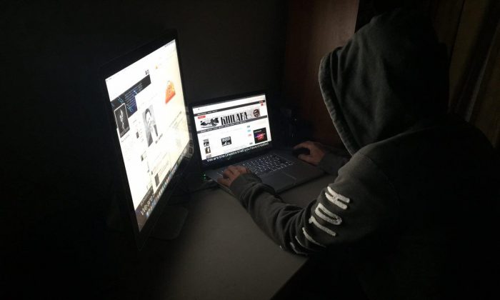 An operative of the hacker group GhostSec works at a laptop. The organization was formed to fight ISIS terrorists by targeting their online fundraising and recruitment. (GhostSec)