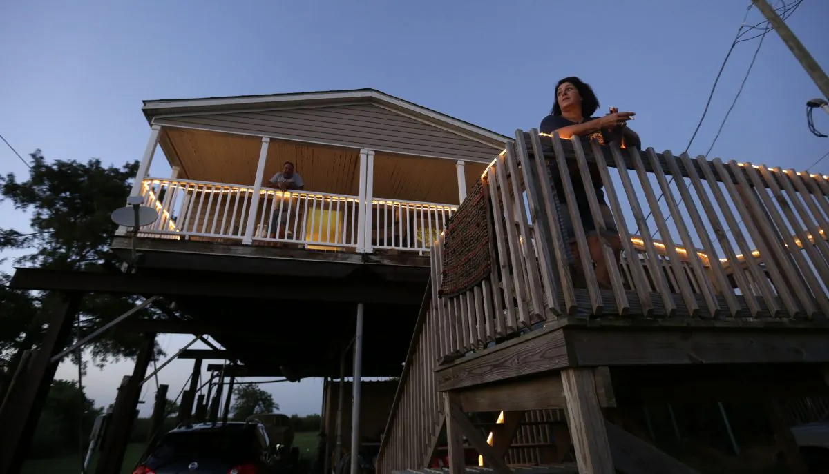 Rocky Morales and Suzanne Guidroz at their home, rebuilt after the previous one was destroyed in Hurricane Katrina, in Delacroix, La., on Aug. 5, 2015. (AP Photo/Gerald Herbert)