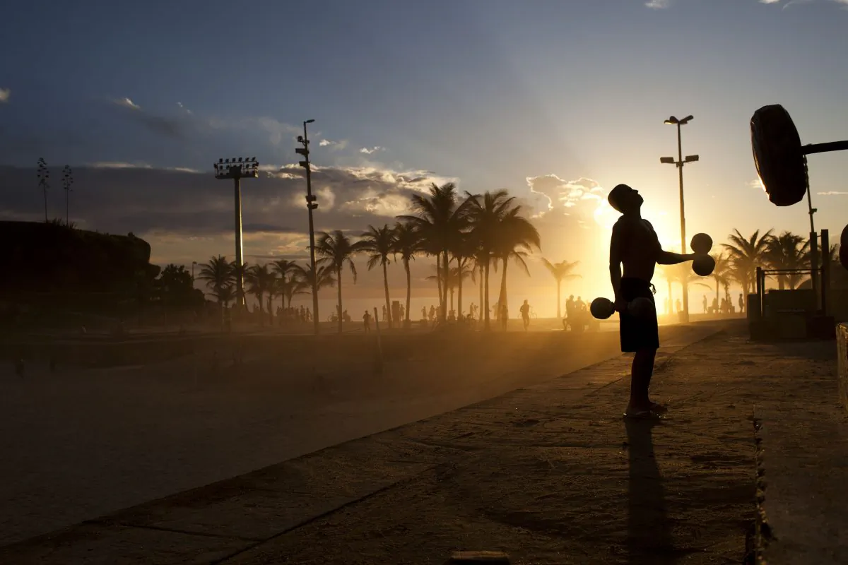 A man works out at sunset at the Arpoador beach in Rio de Janeiro, Brazil, Friday, Dec. 16, 2011. (AP Photo/Felipe Dana)