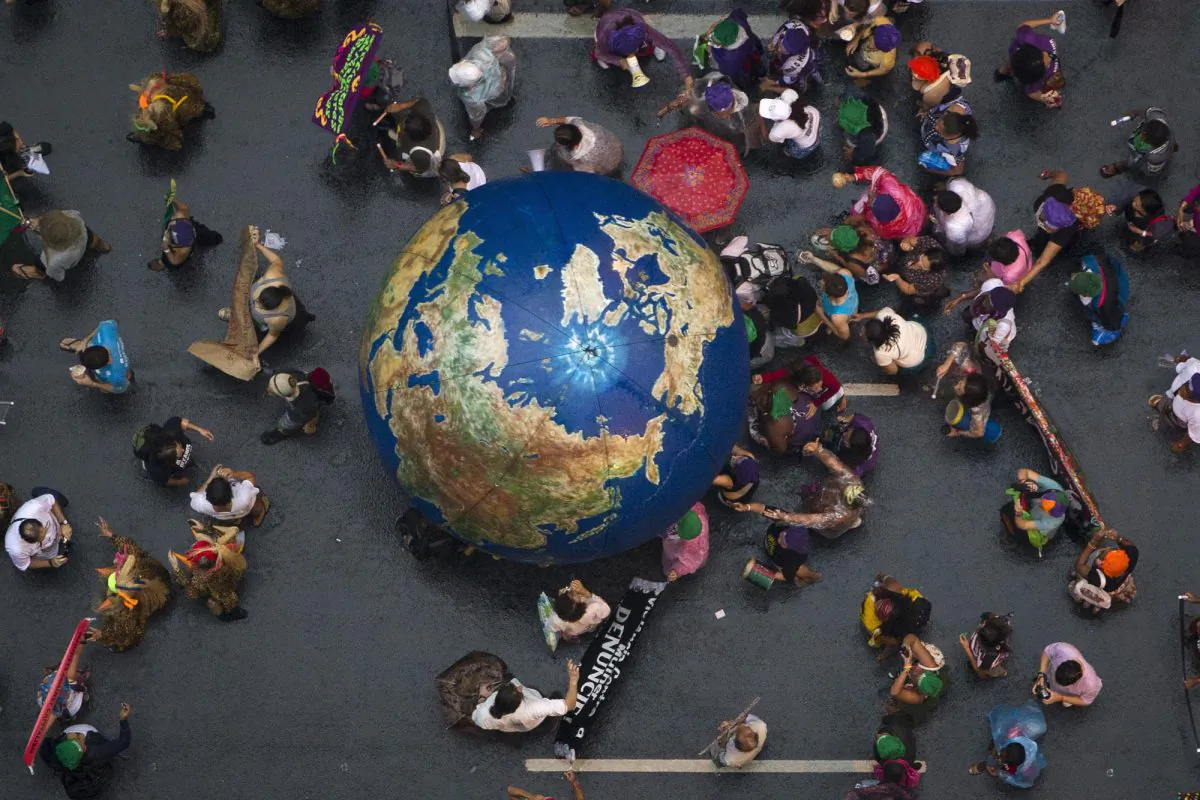 Activists push an inflatable globe during a "Global March" as part of the People's Summit for Social and Environmental Justice in Defense of the Commons, a parallel event during the U.N. Conference on Sustainable Development, or Rio+20, in Rio de Janeiro, Brazil, on June 20, 2012. (Felipe Dana/AP Photo)