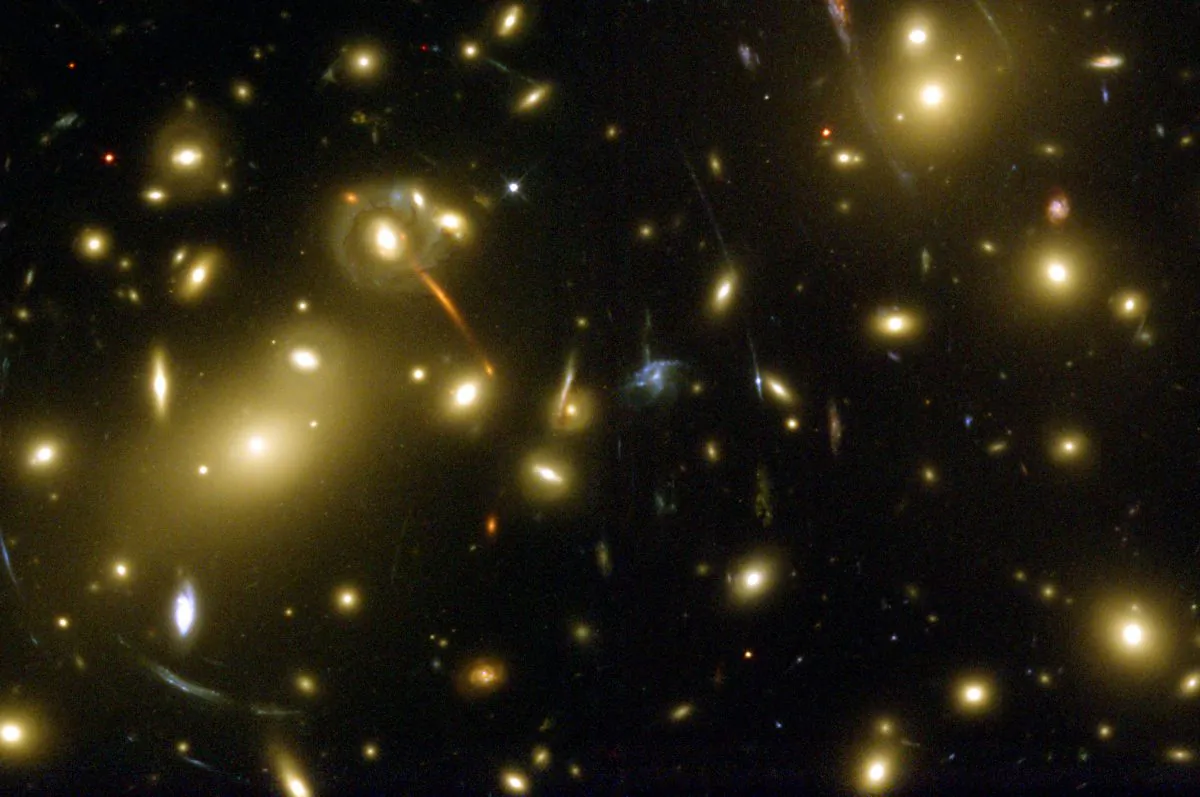 We are a big step closer to tracking down what’s hiding in galaxy clusters like Abell 2218. (NASA/ESA via wikipedia)