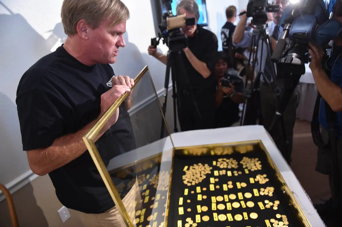 Treasure hunter Brent Brisben, captain and owner of 1715 Fleet - Queens Jewels LLC, displays their recent discovery of more than 350 gold coins valued at $4.5 million found off the coast of Wabasso Beach on July 30-31, 2015, during a news conference, Thursday, Aug. 20, 2015 in Sebastian, Fla. (Eric Hasert/The Stuart News via AP)