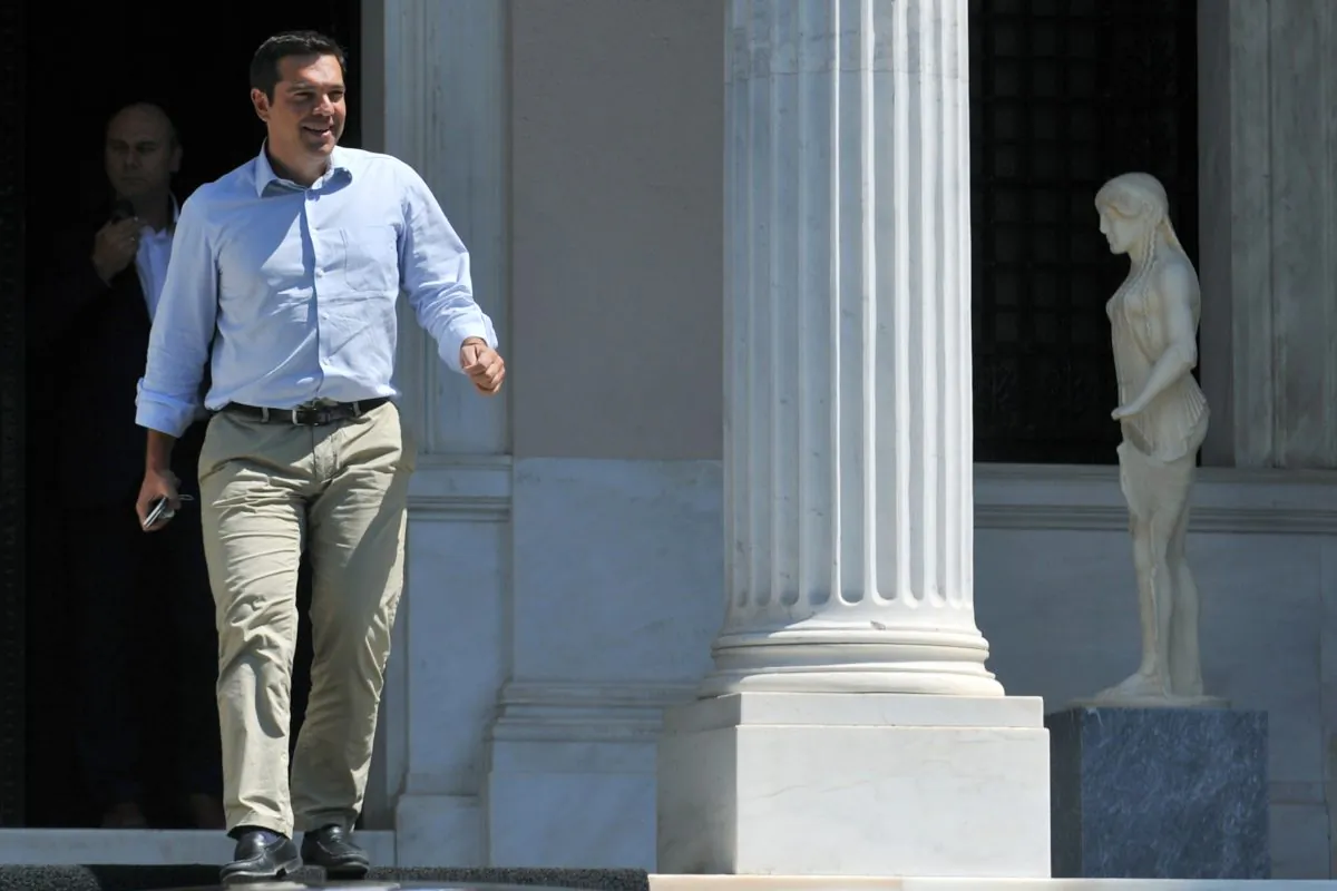 Greek Prime Minister Alexis Tsipras leaves his office in Athens, on Thursday, Aug. 20, 2015. Tsipras has been contemplating his options after a parliament vote to approve the bailout conditions led to dozens of his own party lawmakers voting against him. Among the options being discussed are for him to call a vote of confidence in his government or to call an early election outright, potentially in September.(Giannis Kotsiaris/ InTime News via AP) GREECE OUT