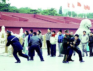 Denied their right under China's constitution to peacefully appeal the unlawful persecution against them, Falun Gong practitioners are arrested by CCP officials at Tiananmen Square. (Photo by Global Photos/Liaison/Getty Images)