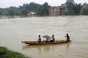 Residents of Fujian residents flee their home, steering their small boat through the flood, June 22, 2005. (Getty Images) Residents of Fujian residents flee their home, steering their small boat through the flood, June 22, 2005. (Getty Images)