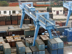 A giant crane unloads cargo containers at a train yard in Beijing. (Goh Chai Hin/AFP/Getty Images)