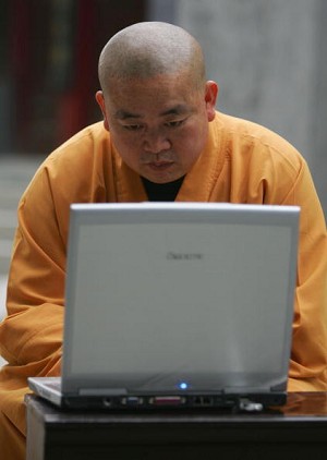 Shi Yongxin, abbot of the Shaolin Temple, works on the computer April 8, 2005 in Dengfeng, Henan Province, China. (Cancan Chu/Getty Images)