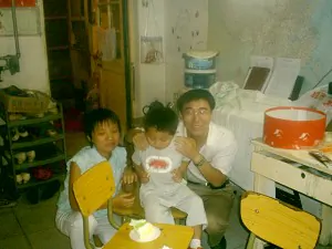 Beijing family church leaders Xu Yonghai (R) and Li Shanna (L) celebrate church member Liu Fenggang's son's birthday. (The Epoch Times)