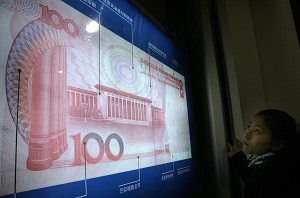 A Chinese girl looks at a 100 yuan note on display at a museum in Beijing. (Goh Chai Hin/AFP/Getty Images)