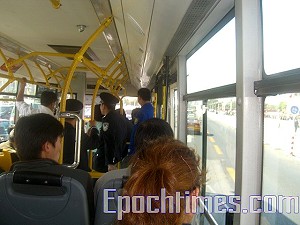 Officers ride every bus that passes Tiananmen Square. (The Epoch Times)