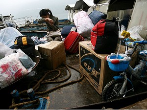 A resident whose home was demolished to make way for the Three Gorges dam breaks into tears as she sets out to leave her hometown by boat at the Wushan Wharf in Wushan County of Chongqing Municipality, China. (China Photos/Getty Images) A resident whose home was demolished to make way for the Three Gorges dam breaks into tears as she sets out to leave her hometown by boat at the Wushan Wharf in Wushan County of Chongqing Municipality, China. (China Photos/Getty Images)