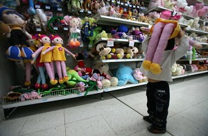 A child holds a toy at a Wal-Mart supermarket September 23, 2007 in Chongqing Municipality, China. (China Photos/Getty Images)