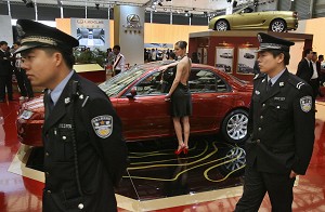 Chinese police walk past MG cars in the Nanjing Auto companies display at the Auto Shanghai exhibition, 21 April 2007. Nanjing Auto's MG brand, bought from Britain's defunct MG Rover group, will spearhead the Chinese company's efforts to export cars to Europe in the second half of the year with sales in China getting underway at the same time. (Mark Ralston/AFP/Getty Images)