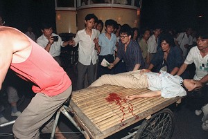 A girl wounded during the clash between the army and students June 4, 1989 near Tiananmen Square is carried out by rickshaw driver. (Manuel Ceneta/AFP/Getty Images)
