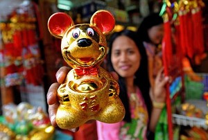 A vendor holds up a golden rat figurine at a street stall in Manila, Philippines. (Jay Directo/AFP/Getty Images) 