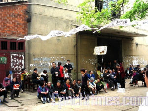 Employees and former employees at the Huayun Factory protest the lack of benefits mandated by Chin's labor laws. They have requested a government investigation into possible corruption regarding the matter. (The Epoch Times)