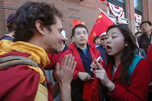 A Tibetan supporter facing a Chinese female. (Kara Andrade/AFP/Getty Images) 