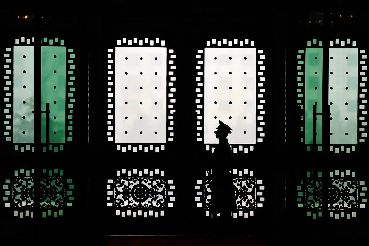A People's Liberation Army guard stands guard at Bayi Building in Beijing on February 21, 2014. The Chinese regime uses special agents to threaten Chinese expats and their families. (Lintao Zhang/AFP/Getty Images)