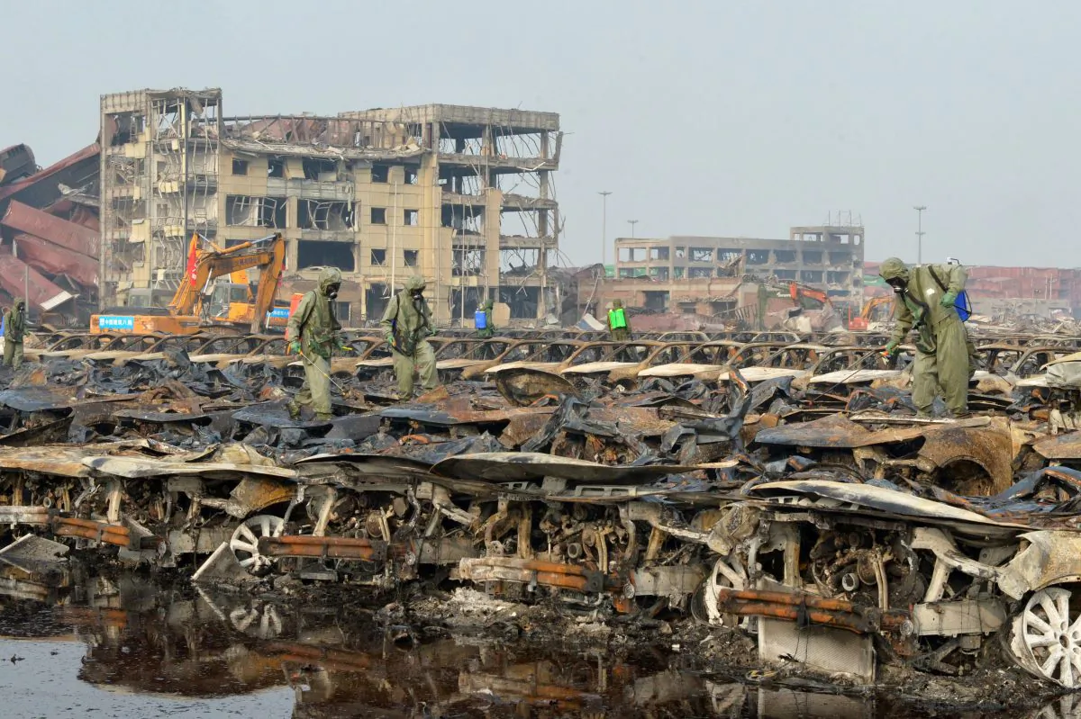 Workers in decontamination suits cleaning up the site of the explosions in Tianjin, China on Aug. 20, 2015. (STR/AFP/Getty Images)