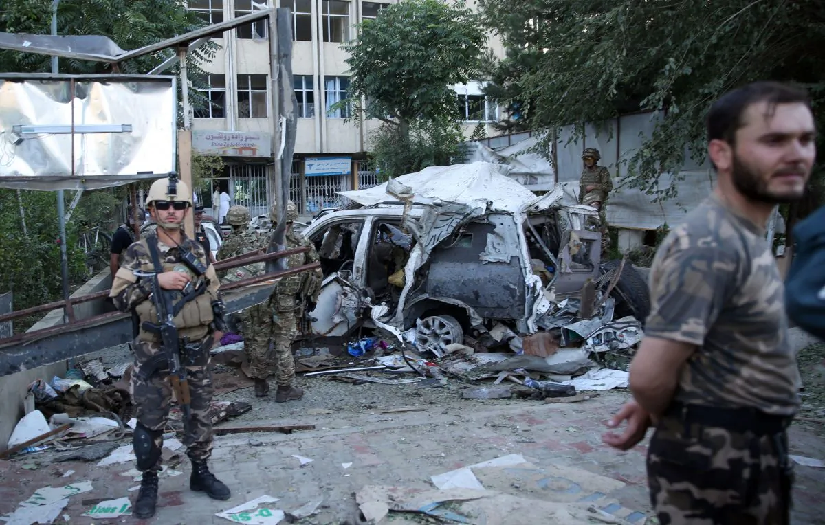 Afghan security forces and British soldiers inspect the site of a suicide attack in the heart of Kabul, Afghanistan, Saturday, Aug. 22, 2015. (AP Photo/Massoud Hossaini)