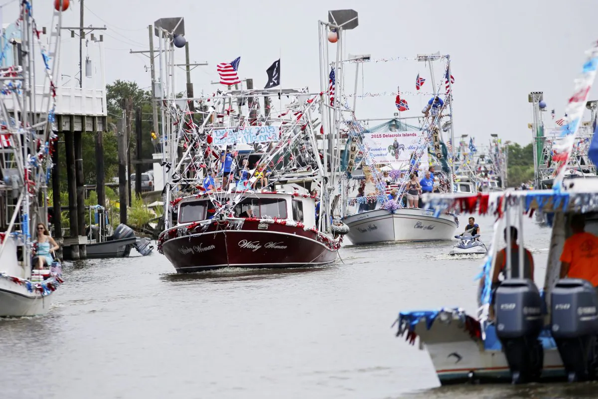 Boats line up in Bayou Terre aux Boeufs during the blessing of the fleet in Delacroix, La., Saturday, Aug. 8, 2015. It was the first blessing of the fleet since the coastal fishing and shrimping community was devastated by Hurricane Katrina a decade ago. (AP Photo/Gerald Herbert)
